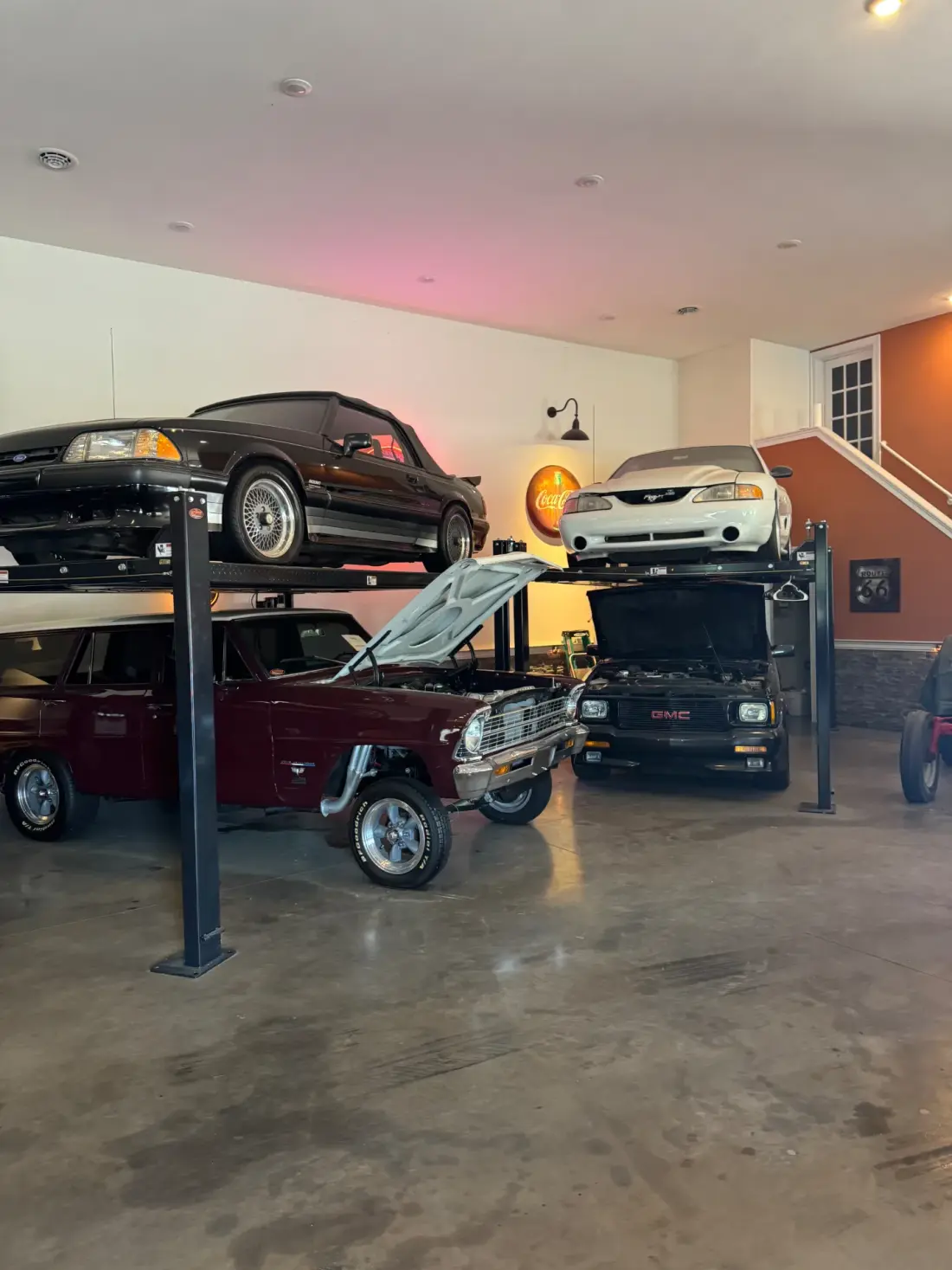 The Speed Shop interior with cars on lifts and auto repair work in progress